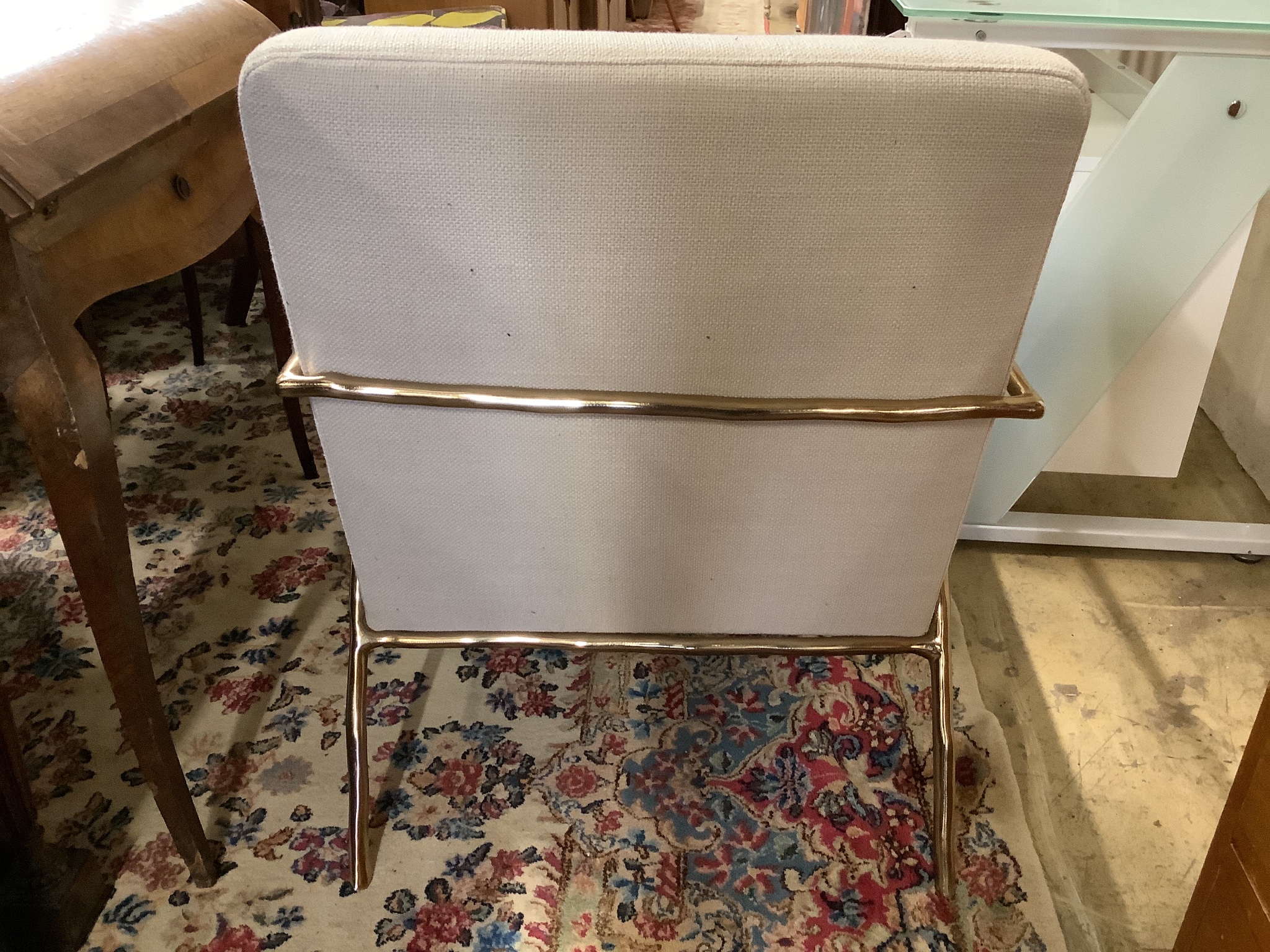 A contemporary brass and natural fabric armchair, width 63cm, depth 77cm, height 72cm